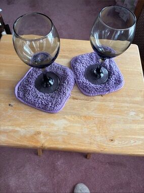 Set of 2 beautiful wine glasses with purple stems.
